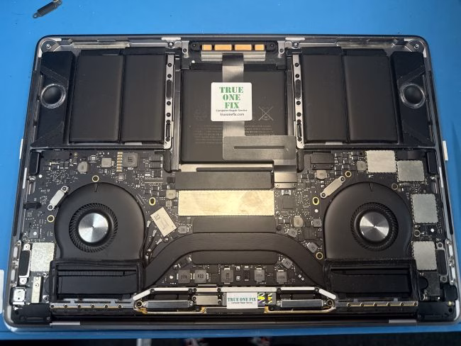 MacBook battery replacement being performed by a technician in Tampa